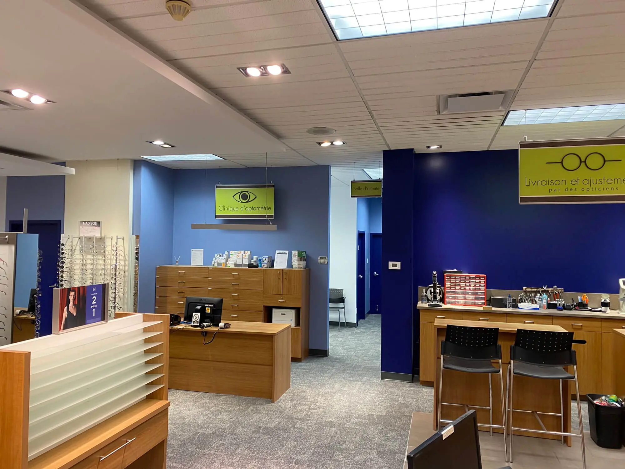 Modern commercial interior office painting featuring professional blue accent walls and wood cabinetry by Pro Paint Plus.