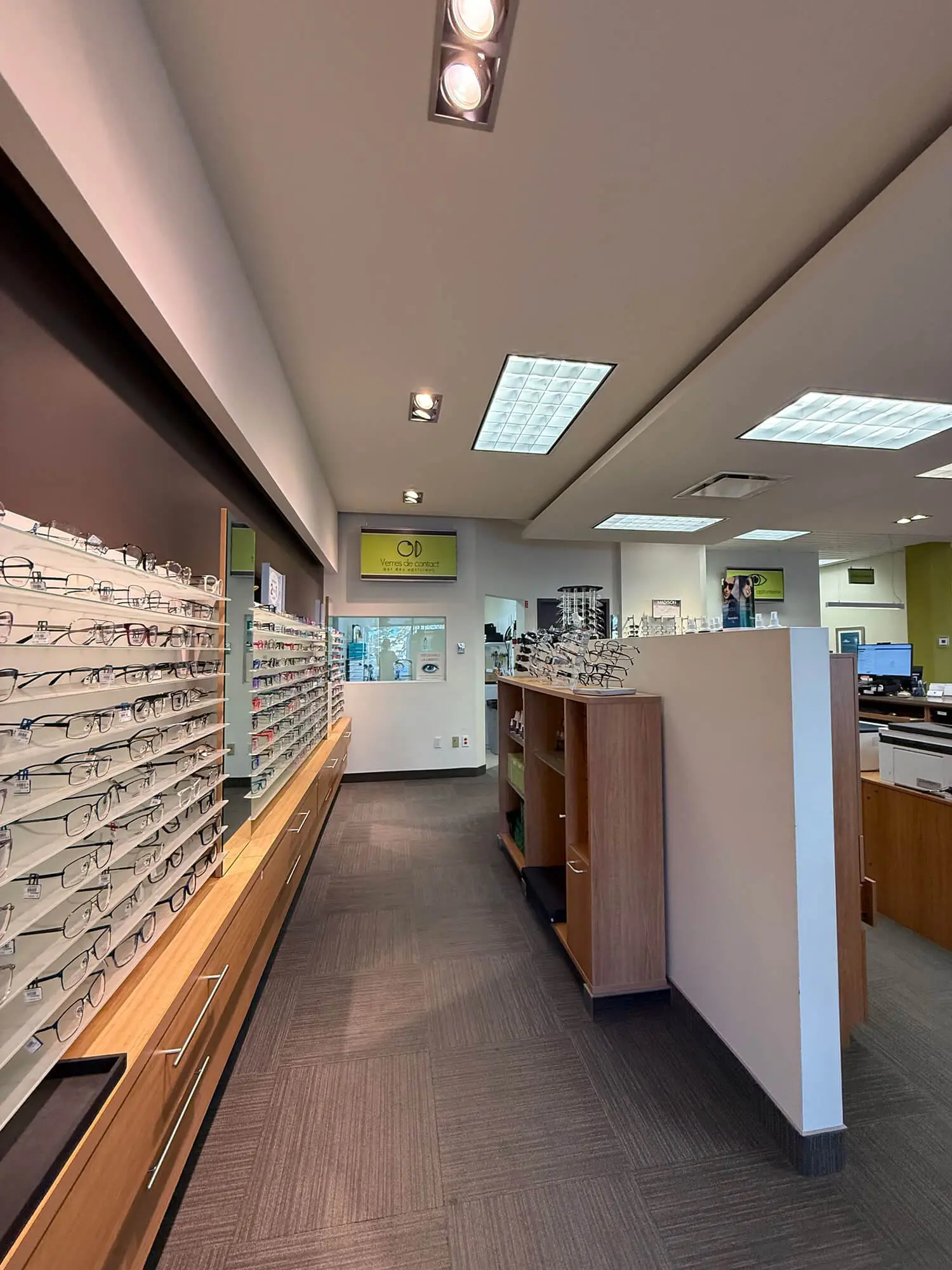 Pro Paint Plus precision interior painting of modern optical boutique showcasing crisp white partitions and deep chocolate accent walls.