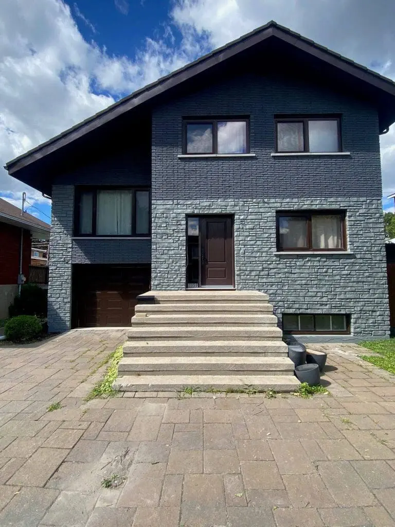 Modern residential exterior featuring a two-tone charcoal and grey stone finish professionally updated by Pro Paint Plus.